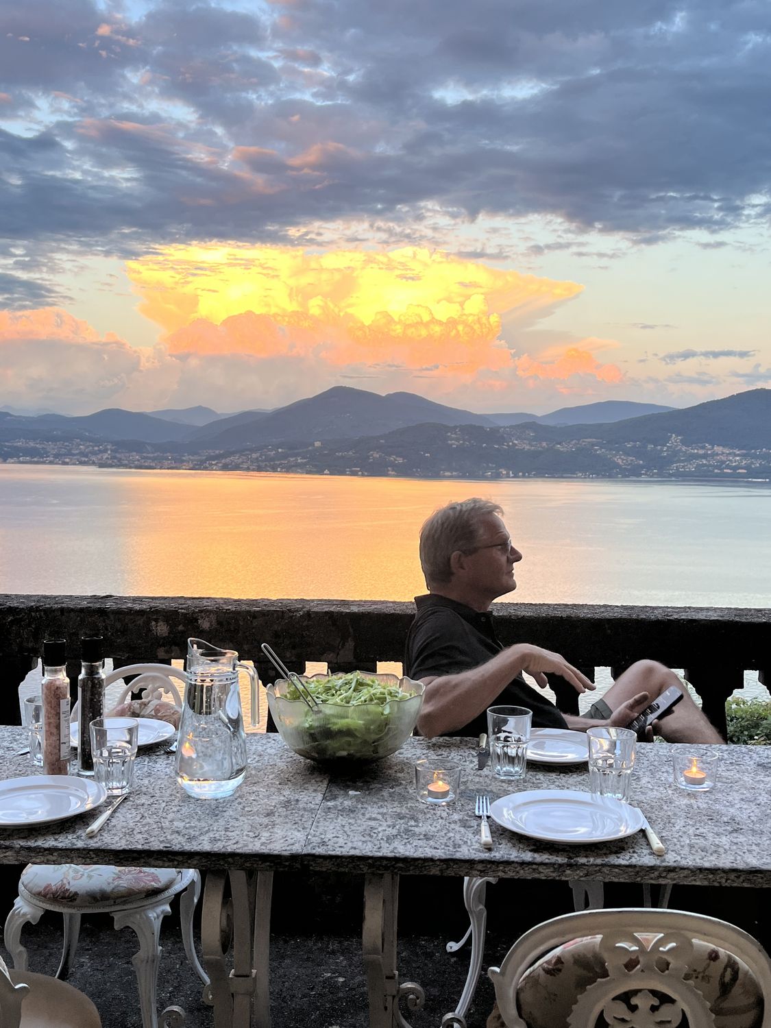 Dinner on the balcony as the evening sky turns gold over the lake