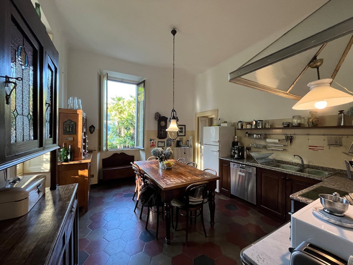 The kitchen with its long table, cabinets and garden window