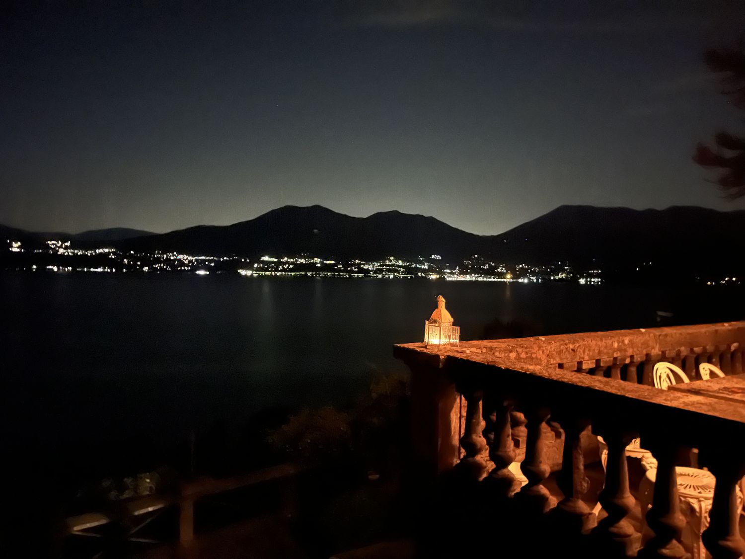 Night view from the balcony with village lights across the lake