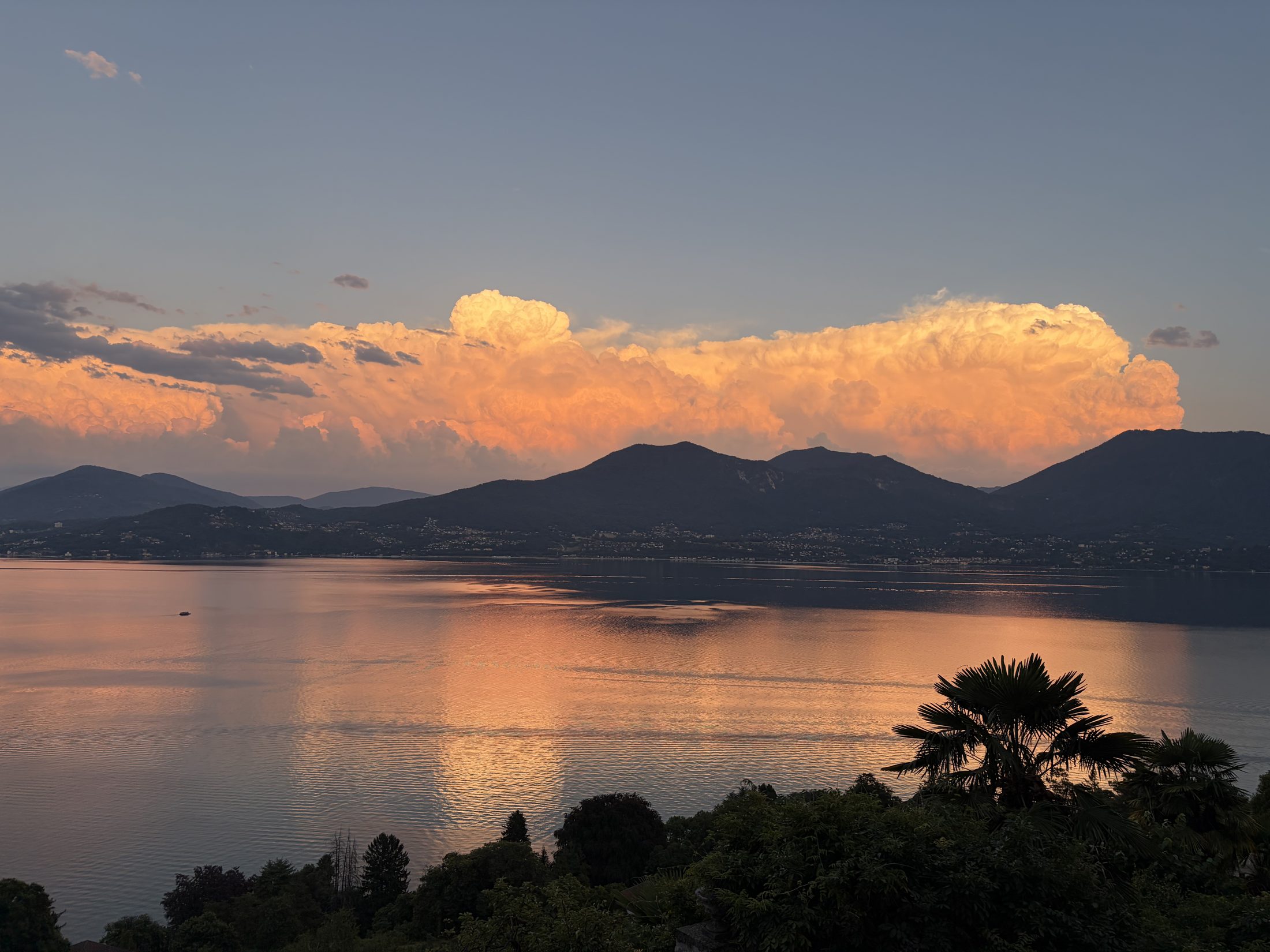 Glowing evening clouds over the mountains and Lake Maggiore, seen from the villa